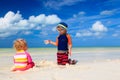 Cute little boy and toddler girl play on beach Royalty Free Stock Photo