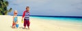 Cute little boy and toddler girl play with sand on beach Royalty Free Stock Photo