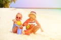 Cute little boy and toddler girl play with sand on beach Royalty Free Stock Photo