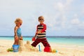 Cute little boy and toddler girl play with sand on beach Royalty Free Stock Photo