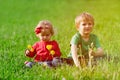 Cute little boy and toddler girl playing on green grass Royalty Free Stock Photo