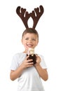 Cute little boy with toy reindeer horns holding mason jar of hot chocolate on white background Royalty Free Stock Photo