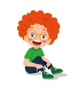 Cute little boy tying his shoelaces Royalty Free Stock Photo