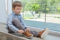 Cute little boy tying shoe laces at home, space for text Royalty Free Stock Photo