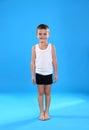 Cute little boy in underwear on light blue background