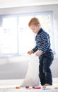 Cute little boy unpacking bag with toys Royalty Free Stock Photo