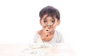 Cute little boy use magnifier looking money