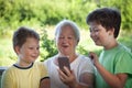 Cute little boy using smartphone with grandma at home veranda Royalty Free Stock Photo