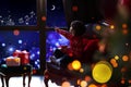 Cute little boy waiting for Santa Claus near window. Christmas holiday Royalty Free Stock Photo