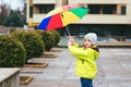 Cute little boy walking in city on rainy day. Child with umbrella outdoors Royalty Free Stock Photo