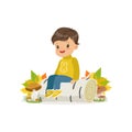 Cute little boy in warm clothing sitting on the birch log in autumn forest, lovely kid enjoying fall, autumn kids