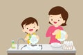 Cute boy washing dish with mother