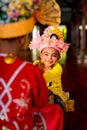 Cute little boy with wear traditional cloth for Poy Sang Long activity look at camera and smile during other help to make cosmetic