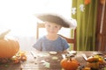 Cute little boy wearing pirate costume on Halloween trick or treat. Kids carving pumpkin lantern. Children celebrate Halloween in Royalty Free Stock Photo