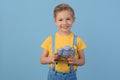 Child and Easter. Smiling blond boy, 6 years old, is holding a colors eggs.