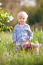 Cute little boyin the garden with blosoming lilac bushes. Smiling boy having fun and enjoying