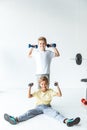 cute little boys exercising with dumbbells and looking at camera