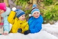 Cute little boys play snowball fight in park Royalty Free Stock Photo