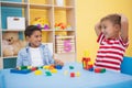 Cute little boys playing with building blocks