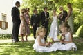 Cute Little Bridesmaids Holding Bouquets In Garden