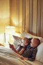 Cute little brother and sister watching videos before bedtime Royalty Free Stock Photo