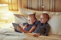 Smiling little brother and sister watching videos before bedtime Royalty Free Stock Photo
