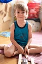 Cute little candid five year old kid boy playing at home with children`s toys cars and the wooden road on a floor of room in a co Royalty Free Stock Photo