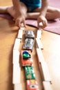 cute little candid five year old kid boy playing at home with children`s toys cars and the wooden road on a floor of room in a co Royalty Free Stock Photo