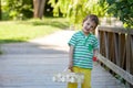 Cute little caucasian boy, eating strawberries in the park Royalty Free Stock Photo