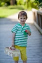 Cute little caucasian boy, eating strawberries in the park Royalty Free Stock Photo