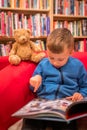 Boy browsing through book in a bookstore Royalty Free Stock Photo