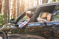 Cute little caucasian boy sitting inside the car and looking out the window. Family road trip Royalty Free Stock Photo