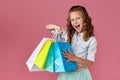 cute little caucasian child girl holds shopping bags Royalty Free Stock Photo
