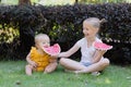 Cute little caucasian girl and her baby sister eating watermelon outdoor at hot summer day. Kids siblings spending time Royalty Free Stock Photo