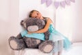 little caucasian girl hugs big gray teddy bear Royalty Free Stock Photo