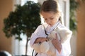 Little girl child act as doctor cure teddy bear