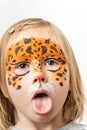 Cute little caucasian girl with tiger face painting on the white background. Close up portrait of little kid with face-painting. Royalty Free Stock Photo