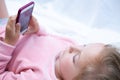 Child girl playing on smartphone