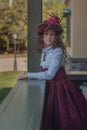 Cute little caucasian girl wearing retro clothes. Nice female child in beautiful vintage dress. Royalty Free Stock Photo