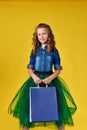 cute little caucasian redhead child girl holds shopping bags Royalty Free Stock Photo