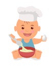 Cute little chef. Toddler in a cook cap with a spoon and an egg in the hands knead the dough.