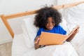 A cute little child African American girl reading a book Royalty Free Stock Photo