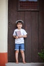 Cute little child, boy, holding big metal key and a book, willin Royalty Free Stock Photo