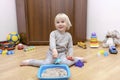 Cute little child boy playing at home in sensory box with kinetic sand.Development of fine motor skills. Early sensory education. Royalty Free Stock Photo