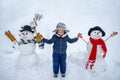 Cute little child boy on snowy field outdoor. Child boy Having Fun in Winter Park. Winter children in frosty winter Park Royalty Free Stock Photo