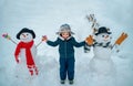 Cute little child boy on snowy field outdoor. Child boy Having Fun in Winter Park. Winter children in frosty winter Park Royalty Free Stock Photo