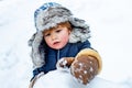 Cute little child boy on snowy field outdoor. Merry Christmas and Happy new year. Winter portrait of little boy child in Royalty Free Stock Photo