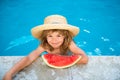 Cute little child boy in the swimming pool eating watermelon. Enjoy eating tropical fruit. Summer kids concept. Happy Royalty Free Stock Photo