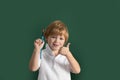 Cute little child drawing in classroom. Portrait of school boy enjoying art and craft lesson in school. Kids early arts Royalty Free Stock Photo