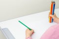 Child is drawing by colored pencils Royalty Free Stock Photo